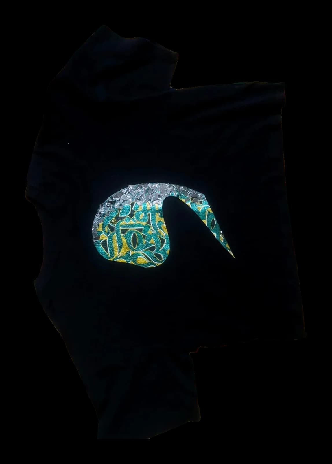 Aaina — black tee with metallic leather vao over mirror mosaic